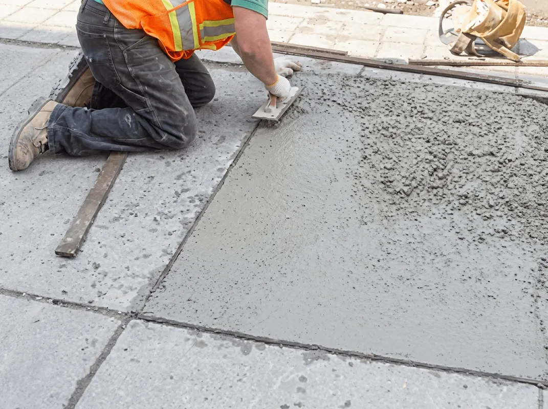 Professional repairing a concrete floor in Fargo, ND